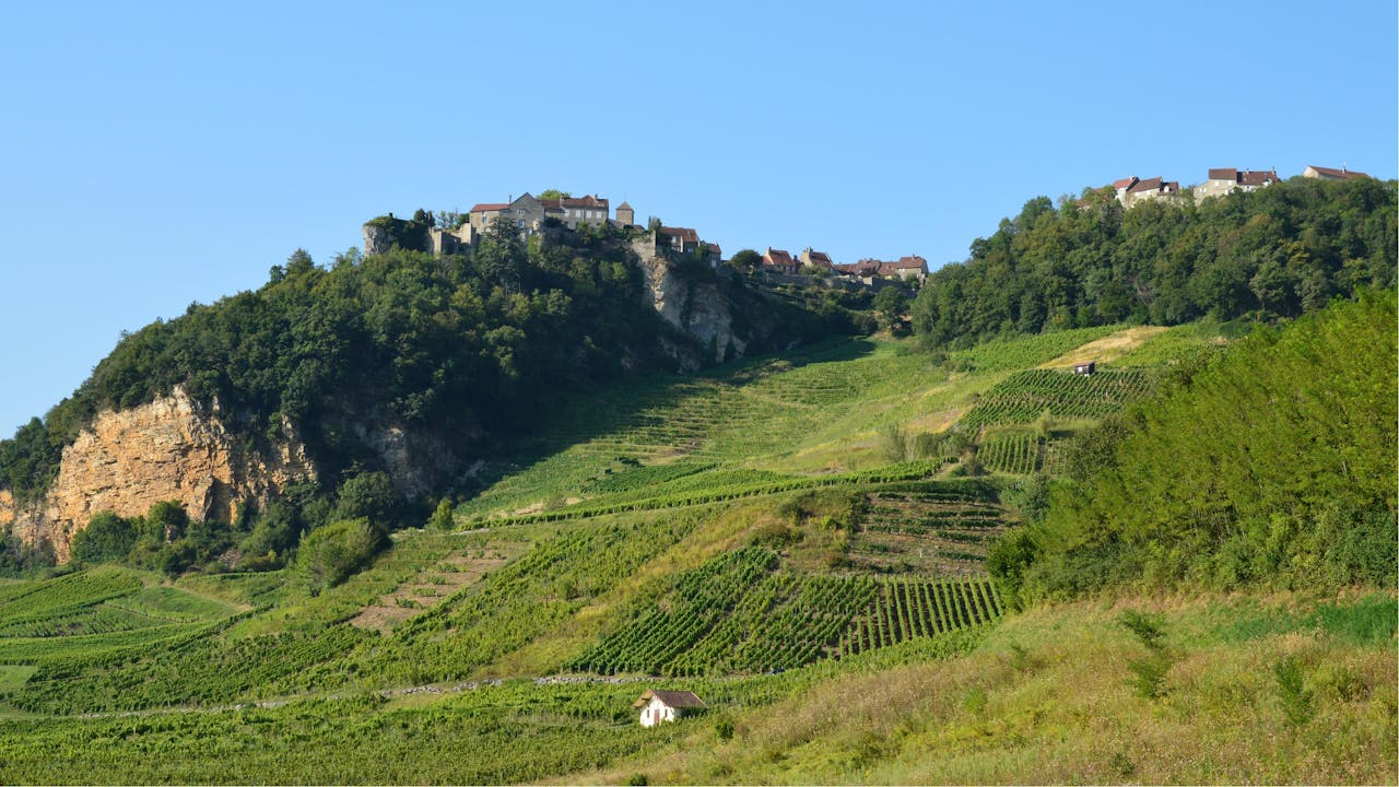 Scenic view of Château-Chalon with vineyards and hillside landscape in Bourgogne-Franche-Comté, France.